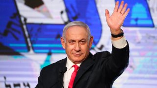 In this March 24, 2021, file photo, Israeli Prime Minister Benjamin Netanyahu waves to his supporters after the first exit poll results for the Israeli parliamentary elections at his Likud party's headquarters in Jerusalem.