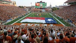 FILE - Fans sing “The Eyes of Texas” before the start of the NCAA football game between the Texas Longhorns and the Rice Owls on Sept. 3, 2011, at Darrell K. Royal-Texas Memorial Stadium in Austin, Texas.