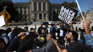 Demonstrators dance and sing outside the Georgia State Capitol