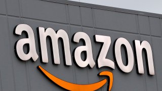 A sign is lit on the facade of an Amazon fulfillment center, Thursday, March 19, 2020, on Staten Island in New York.