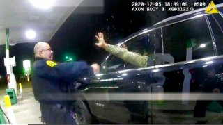 In this image made from Windsor, (Va.) Police video, a police officer uses a spray agent on Caron Nazario on Dec. 20, 2020, in Windsor, Va. Nazario, a second lieutenant in the U.S. Army, is suing two Virginia police officers over a traffic stop during which he says the officers drew their guns and pointed them at him as he was dressed in uniform. Caron Nazario says his constitutional rights were violated by the traffic stop in the town of Windsor in December. (Windsor Police via AP)