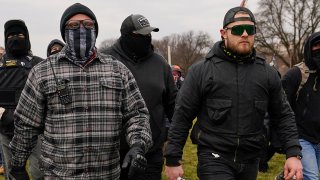 In this Jan. 6, 2021, file photo, Proud Boys members Joseph Biggs, left, and Ethan Nordean, right, walk toward the U.S. Capitol in Washington.