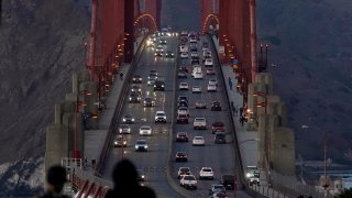In this Nov. 12, 2020, file photo, traffic moves on the Golden Gate Bridge in San Francisco. The San Francisco Chronicle reported Saturday, May 15, 2021, that the iconic span started emanating a loud hum following a retrofit last year of the sidewalk safety railing on its western side. Crews replaced some 12,000 wide slats with narrower ones, to give the bridge a slimmer profile and make it safer in high winds.