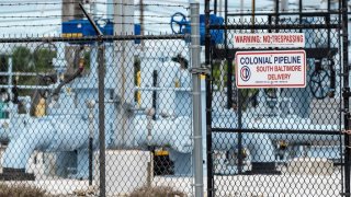 A sign is seen at Colonial Pipeline Baltimore Delivery in Baltimore, Maryland on May 10, 2021. - The US government declared a regional emergency Son May 9, 2021 as the largest fuel pipeline system in the United States remained largely shut down, two days after a major ransomware attack was detected. The Colonial Pipeline Company ships gasoline and jet fuel from the Gulf Coast of Texas to the populous East Coast through 5,500 miles (8,850 kilometers) of pipeline, serving 50 million consumers. The company said it was the victim of a cybersecurity attack involving ransomware -- attacks that encrypt computer systems and seek to extract payments from operators. (Photo by JIM WATSON / AFP) (Photo by JIM WATSON/AFP via Getty Images)