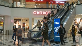 Shoppers wear protective masks inside the Glendale Galleria shopping mall in Glendale, California, on Thursday, May 6, 2021.