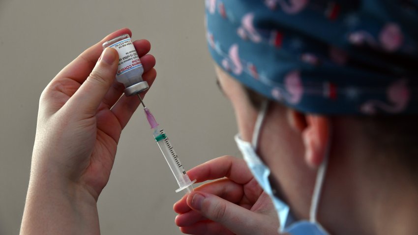 A health care worker prepares a dose of the Moderna Inc. Covid-19 vaccine.