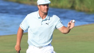 Bryson DeChambeau holds a ball