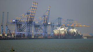 A container ship docked at India’s Adani Port Special Economic Zone (APSEZ) in Mundra, India.