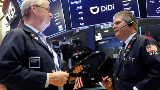 Traders work during the IPO for Chinese ride-hailing company Didi Global Inc on the New York Stock Exchange (NYSE) floor in New York City, U.S., June 30, 2021.