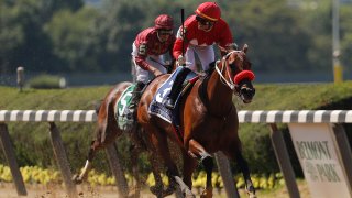 Jose Ortiz, right, reacts as he crosses the finish line with Letruska (3) to win the 53rd running of the Ogden Phipps horse race