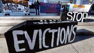 Tenants' rights advocates demonstrate in front of the Edward W. Brooke Courthouse, Wednesday, Jan. 13, 2021, in Boston. The protest was part of a national day of action calling on the incoming Biden administration to extend the eviction moratorium initiated in response to the Covid-19 pandemic.