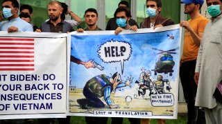 Former Afghan interpreters hold banners during a protest against the U.S. government and NATO in Kabul, Afghanistan