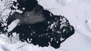 Color satellite image of breakup of ice pack at the mouth of the Pine Island Glacier in Antarctica.