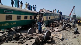 Soldiers and volunteers work at the site of a train collision in Ghotki district in southern Pakistan, Monday, June 7, 2021. Two express trains collided in southern Pakistan early Monday, killing dozens of passengers, authorities said, as rescuers and villagers worked to pull injured people and more bodies from the wreckage.