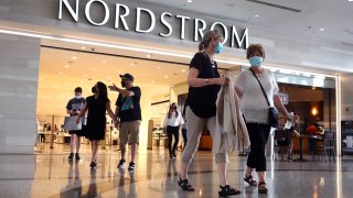 Shoppers leave a Nordstrom store on May 26, 2021 in Chicago, Illinois.