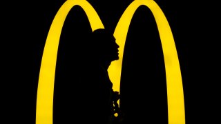 A pedestrian walks past an American fast-food hamburger restaurant chain McDonald’s logo seen in Hong Kong.