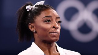 USA’s Simone Biles cheers during the artistic gymnastics women’s team final during the Tokyo 2020 Olympic Games at the Ariake Gymnastics Centre in Tokyo on July 27, 2021.