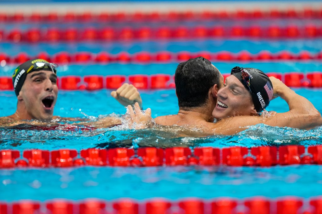 Caeleb Dressel, of United States, celebrates after winning the gold medal in a men's 50-meter freestyle fiat the 2020 Summer Olympics, Sunday, Aug. 1, 2021, in Tokyo, Japan. At left Bruno Fratus, of Brazil, celebrates winning the bronze medal.