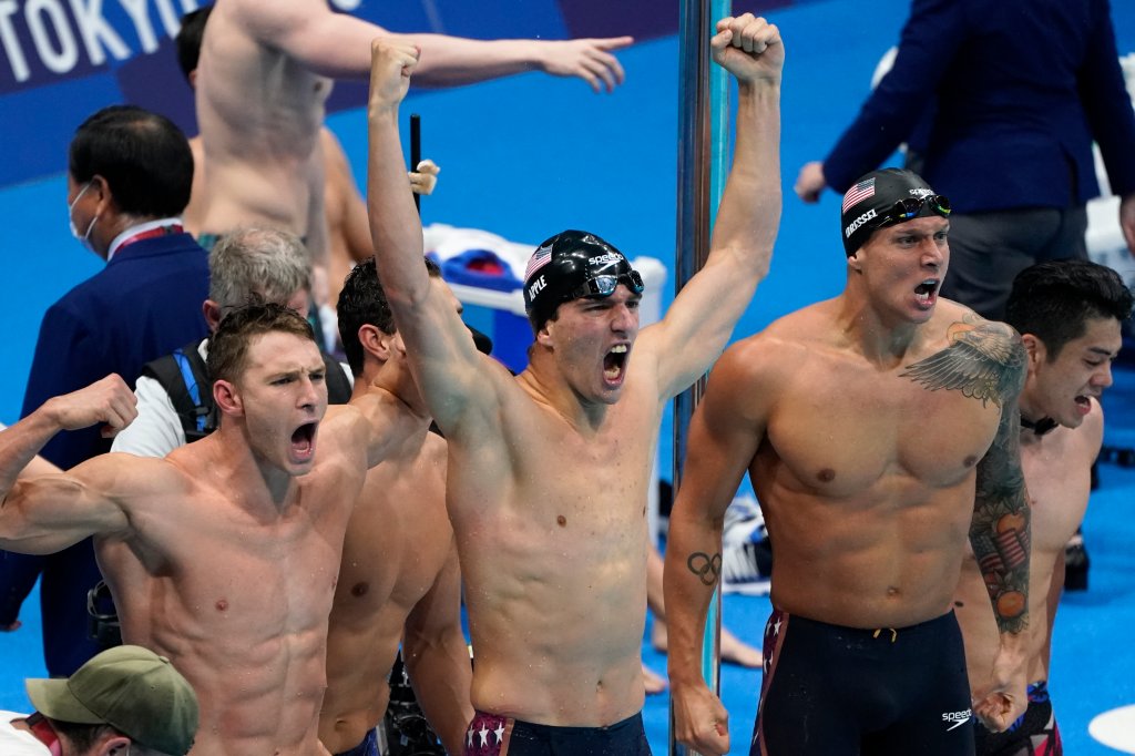 Caeleb Dressel, of United States, right, and teammates celebrate winning the gold medal in the men's 4x100-meter medley relay final at the 2020 Summer Olympics, Sunday, Aug. 1, 2021, in Tokyo, Japan.