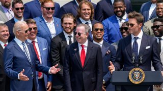 U.S. President Joe Biden laughs as quarterback Tom Brady jokes while speaking as the 2021 NFL Super Bowl champion Tampa Bay Buccaneers are welcomed to the South Lawn of the White House on July 20, 2021 in Washington, DC.