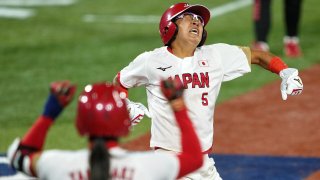 Japan third baseman Yu Yamamoto (5) reacts after scoring against the United States of America on an RBI single hit by designated player Yamato Fujita (not pictured) during the fifth inning in the gold medal game of the Tokyo 2020 Olympic Summer Games