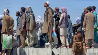 Afghan people who want to leave the country continue to wait around Hamid Karzai International Airport in Kabul, Afghanistan on Aug. 26, 2021.