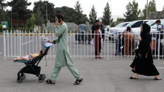 Passengers walk out from the domestic terminal at Hamid Karzai International Airport