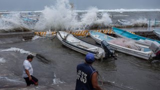 Fishermen remove their boats from the dock in the Veracruz state of Mexico
