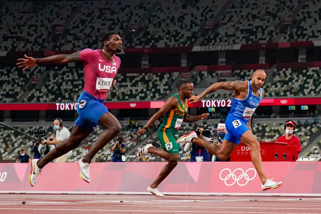 Lamont Jacobs of Italy, right, wins the men's the 100-meter final at the Tokyo Olympics, Sunday, Aug. 1, 2021, in Tokyo. Team USA's Fred Kerley, left, took home silver for the event.