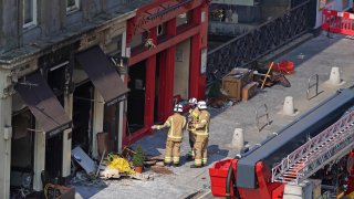 Firefighters at the scene after a fire at the Elephant House Cafe in Edinburgh, Wednesday, Aug. 25, 2021. An Edinburgh cafe where author J.K. Rowling wrote some of the Harry Potter books has been damaged in a fire. The Elephant House in the Scottish capital was blackened by a blaze which broke out at the patisserie next door on Tuesday.