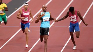 Steven Gardiner of Team Bahamas finishes ahead of Michael Cherry of Team United States and Michael Norman of Team United States to win the gold medal in the Men's 400m Final on day thirteen of the Tokyo 2020 Olympic Games