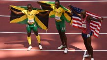 (From L) Third-placed Jamaica's Ronald Levy, first-placed Jamaica's Hansle Parchment and second-placed USA's Grant Holloway celebrate after competing in the men's 110m hurdles final during the Tokyo 2020 Olympic Games at the Olympic stadium in Tokyo on August 5, 2021.