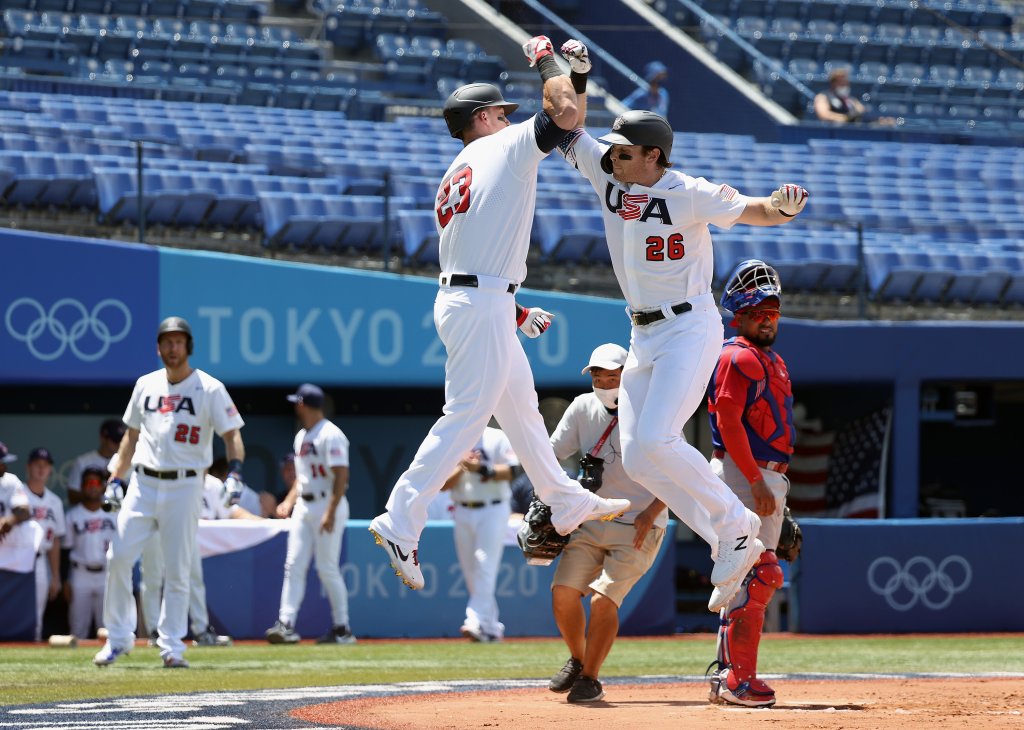 Triston Casas #26 and Tyler Austin #23 of Team United States celebrate Casas' two-run home run as catcher Charlie Valerio #7 Team Dominican Republic looks on in the first inning during the knockout stage of men's baseball on day twelve of the Tokyo 2020 Olympic Games at Yokohama Baseball Stadium on Aug. 4, 2021, in Yokohama, Japan.