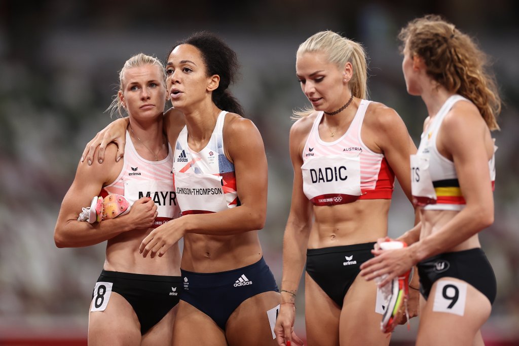 Katarina Johnson-Thompson of Team Great Britain is consoled by Verena Mayr of Team Austria as she walks off the track injured during the Women's Heptathlon 200m heats on day twelve of the Tokyo 2020 Olympic Games at Olympic Stadium on Aug.4, 2021 in Tokyo, Japan. 