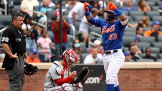 Javier Baez gives thumbs down after crossing homeplate