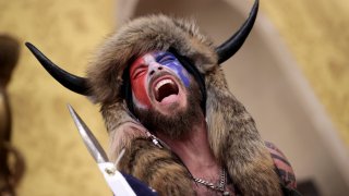 A protester screams “Freedom” inside the Senate chamber after the U.S. Capitol was breached by a mob during a joint session of Congress on January 06, 2021 in Washington, DC.