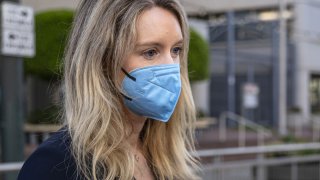 Elizabeth Holmes, founder of Theranos Inc., exits federal court in San Jose, California, on Tuesday, Aug. 31, 2021.