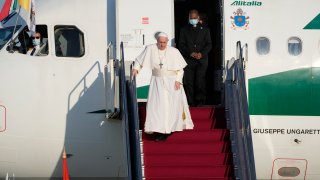Pope Francis walks down the steps on an airplane as he arrives at Budapest international airport, Sunday, Sept. 12, 2021.