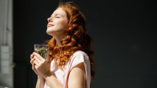 Redheaded woman enjoying sunlight