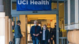 Former President Bill Clinton and former U.S. Secretary of State Hillary Clinton leave the University of California Irvine Medical Center in Orange, Calif.