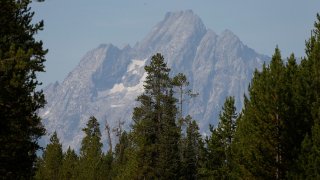The morning sun illuminates the Grand Tetons, in Grand Teton National Park, Wyo., Saturday, Aug 27, 2016. Park activities continue despite wildfires just north of Coulter Bay and in Yellowstone which have closed Teton's north entrance and the south entrance to Yellowstone National Park.