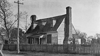 This 1921 image provided by the The Colonial Williamsburg Foundation shows the front elevation of the Dudley Digges House in its original location on Prince George Street, in Williamsburg, Va. The schoolhouse where enslaved and free Black children were taught before the Revolutionary War will be moved from the William & Mary campus to Colonial Williamsburg and restored to its original state, officials announced Friday, Oct. 29, 2021.