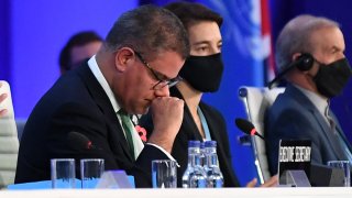 Britain’s President for COP26 Alok Sharma (L) reacts as he makes his concluding remarks during the COP26 UN Climate Change Conference in Glasgow on November 13, 2021.