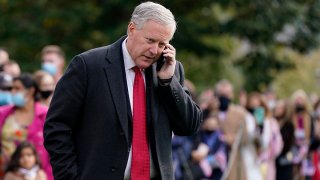 FILE - White House chief of staff Mark Meadows speaks on a phone on the South Lawn of the White House in Washington, on Oct. 30, 2020.