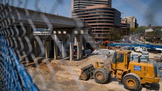 Construction near unfinished Purple Line rail tracks at the Paul Sarbanes Transit Center April 8, 2021, in Silver Spring, Maryland.