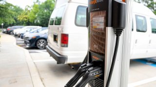 FILE - An electric vehicle charging station at the Homewood Suites by Hilton hotel in Spring Township, Pennsylvania, July 21, 2021.