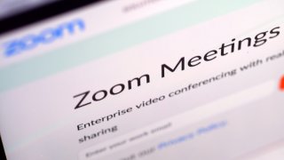 In this photo illustration, the website of Zoom Video Communications Inc is seen
