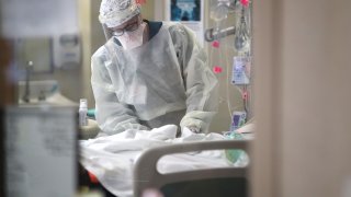A nurse treats a patient with coronavirus in the intensive care unit at a hospita