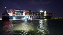 Rescue ships work at the site of the stuck container ship Ever Given on the Suez Canal, Egypt, March 27, 2021. At least 321 vessels were jammed around the Suez Canal awaiting salvage of the giant container ship that has been stuck and blocking the vital waterway.