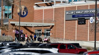 Students and staff gather outside